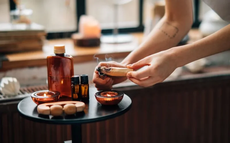 A calming aromatherapy setup with essential oils and incense for relaxation and self-care rituals.