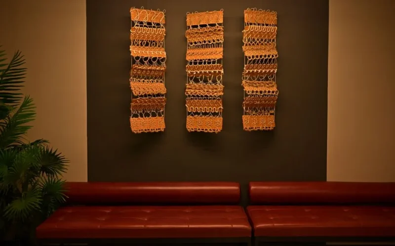 Stylish lounge with leather seating and unique wall art pieces, creating a warm ambient atmosphere.