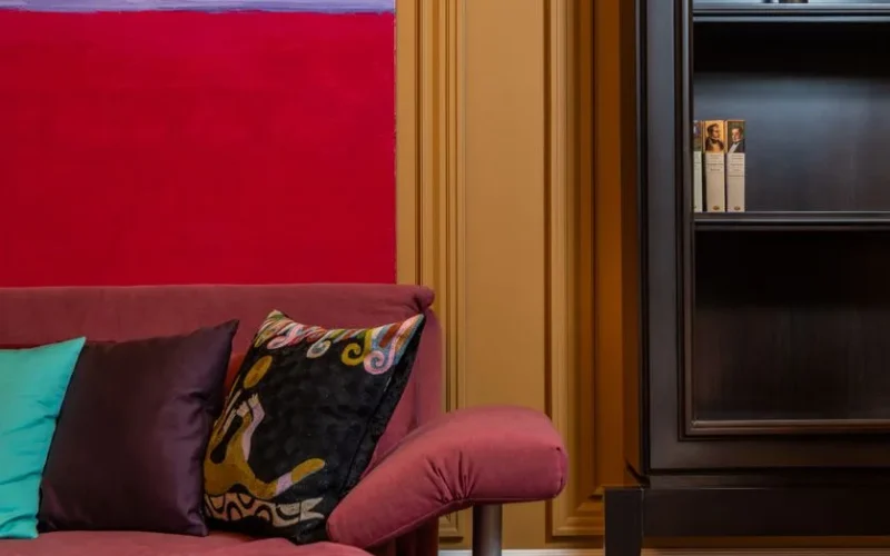 Elegant living room with a vibrant painting, plush sofa, and stylish decor. Perfect for luxury interior design inspiration.