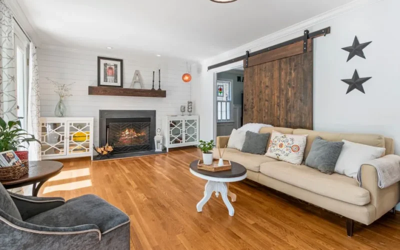 A bright and cozy modern farmhouse living room with fireplace and elegant decor.
