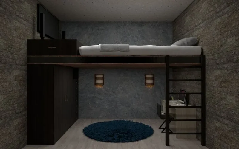 A stylish loft bedroom featuring a bed above a home office space, perfect for maximizing small spaces.