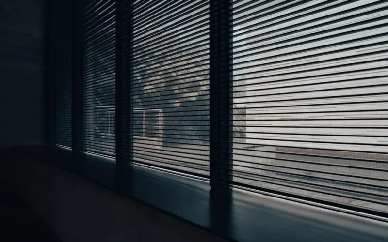 Modern interior space with sleek blinds providing a minimalist aesthetic and diffused natural light.