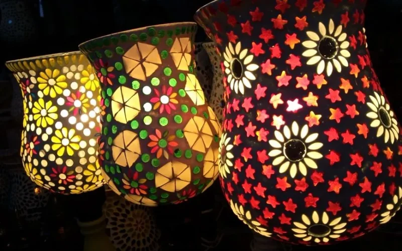 Brightly illuminated mosaic lamps showcasing intricate floral patterns, creating a warm ambiance.