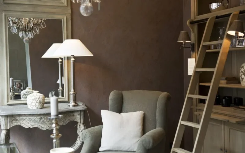 Chic interior featuring an armchair, vintage furniture, and decorative lighting.