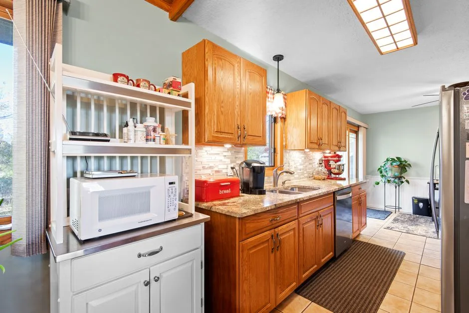 Bright kitchen featuring wooden cabinets, appliances, and natural lighting.