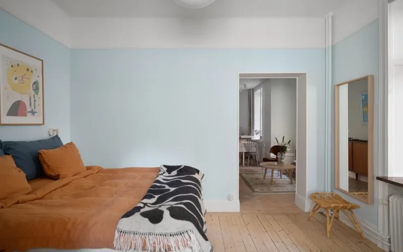 Stylish bedroom showcasing minimalist Scandinavian interior design with warm and cozy decor.
