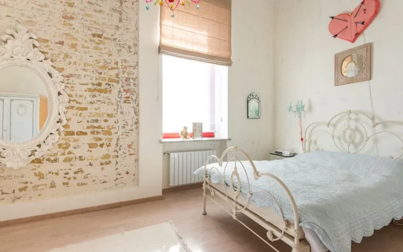 Charming bedroom featuring vintage-style furniture, rustic decor, and a bright, cozy atmosphere.