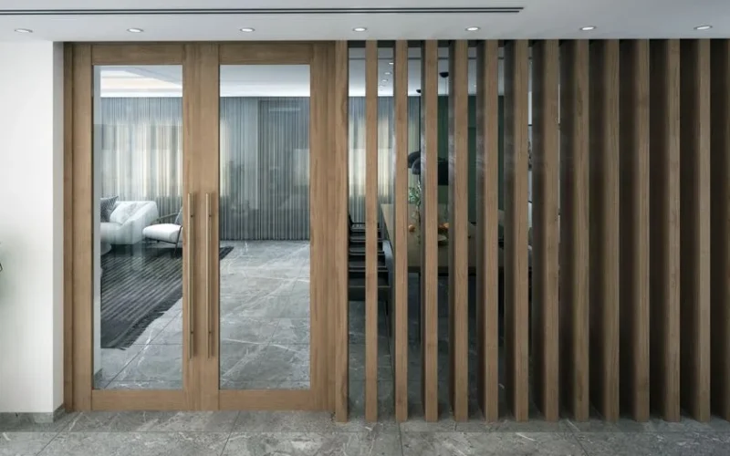 Stylish indoor space featuring a modern glass door with wooden frame and decorative slats.
