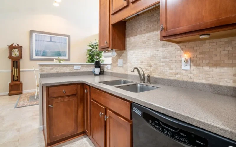 Elegant kitchen interior showcasing granite countertops and wooden cabinets.