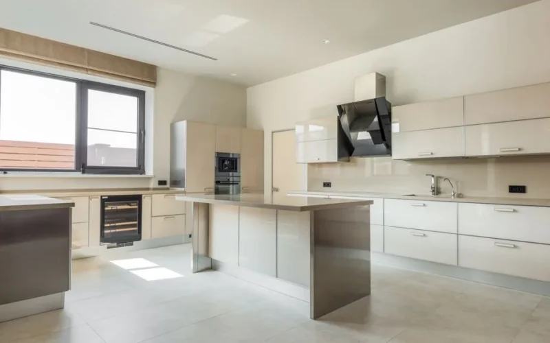 A bright, spacious kitchen featuring minimalist design and modern appliances.