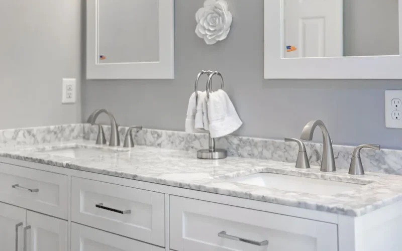 Elegant gray and white bathroom with marble countertop and dual sinks, highlighting interior design.