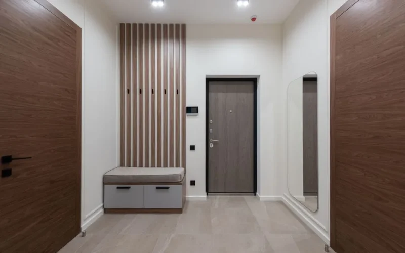 Interior of modern empty spacious hallway with white walls and big mirror in apartment